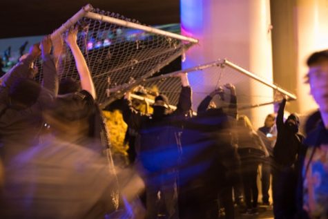 Protesters take down fences to create a path onto Interstate 580 on Nov. 11, 2016 in
Oakland, Calif.