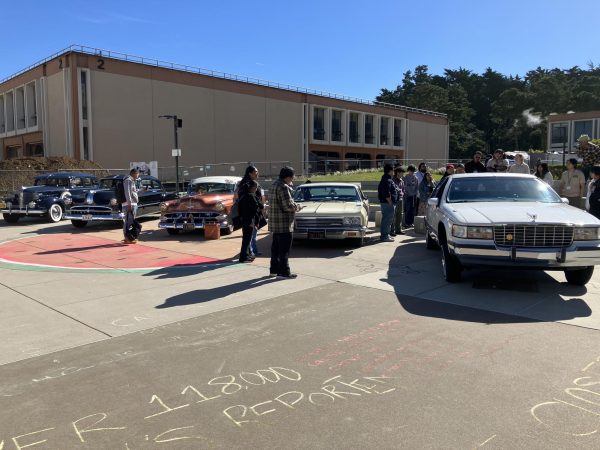 Students admire the lowriders parked in the quad.