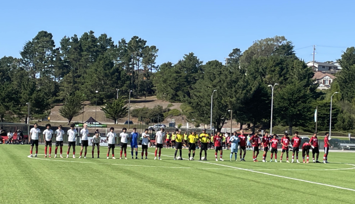 Players stand for the national anthem before the start of the game.