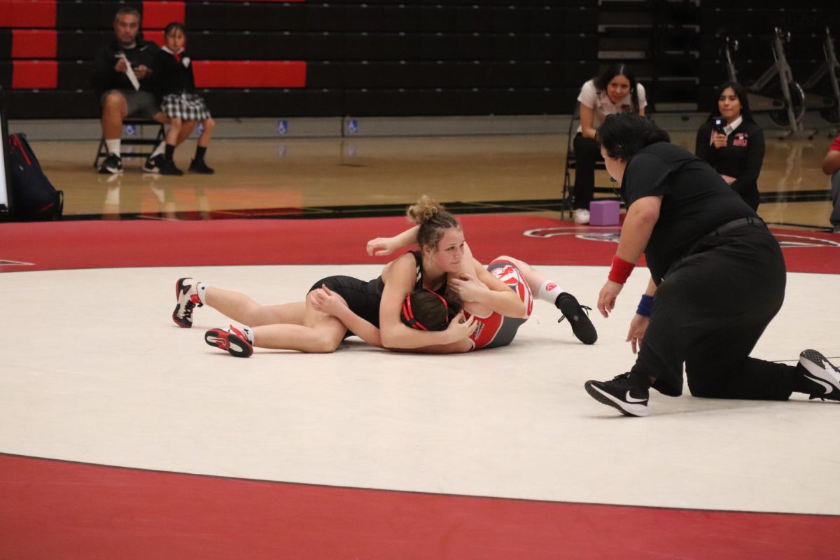 Freshman Jamie Micallef wrestles Santa Rosa Junior College's Lyla Kondrashoff in her second dual match at the meet.