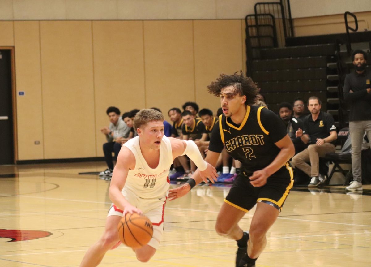 Skyline gaurd Brady Carson slips past Chabot's Amani Johnson.