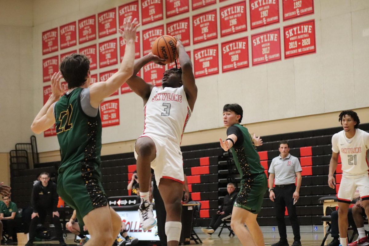 Sophomore point guard Achilles Woodson takes a fade away shot in front of a defender.