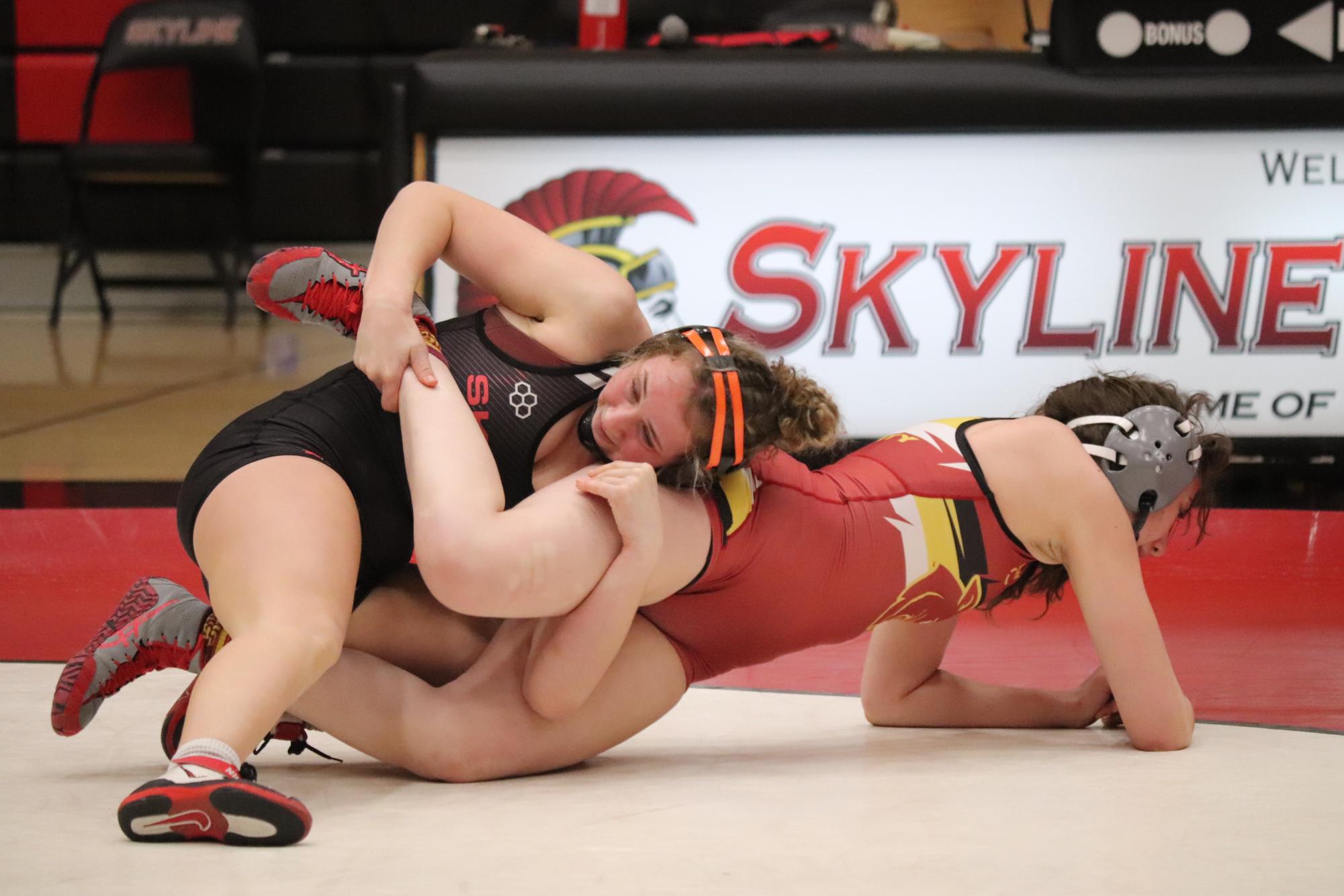 Skyline freshman Jaimie Micallef wrestles Sacramento City College wrestler Kaylee Ceja.