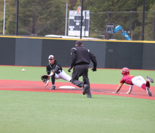 Sophomore shortstop Ethan Reader (left) covers second base to tag the runner out.