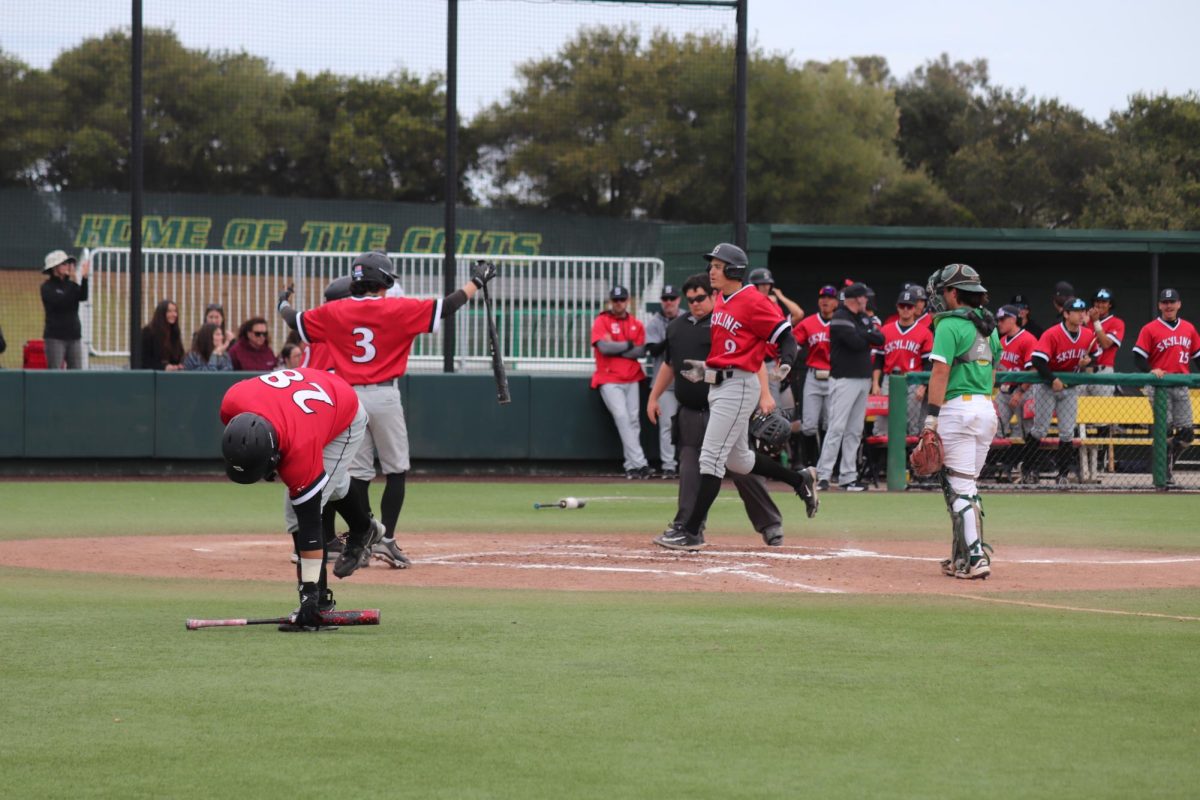 Skyline freshman outfielder Trey Johnson (#9) touches home plate after hitting a home run.